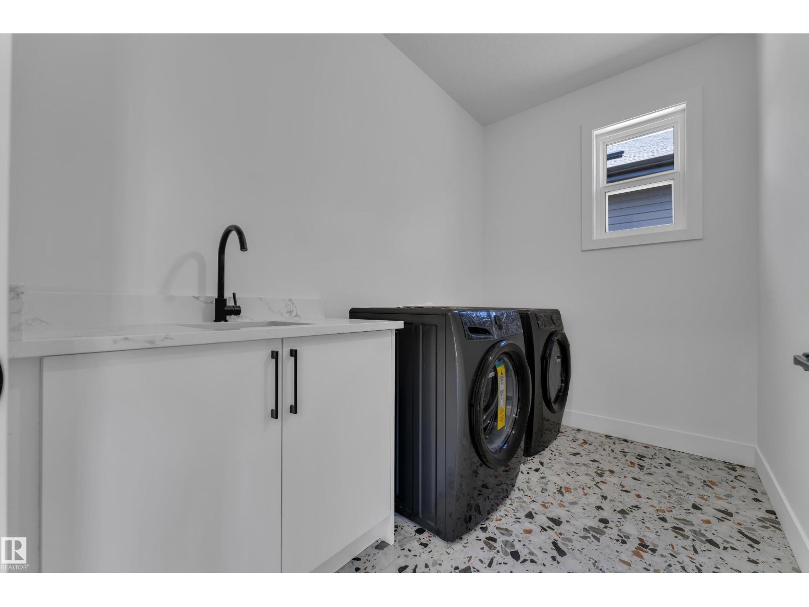 Laundry room with terrazzo floor