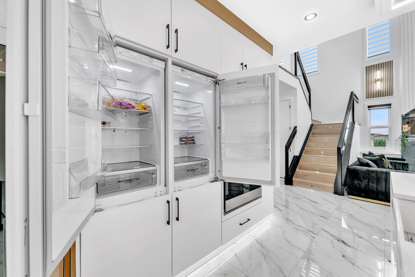 Open-concept great room and kitchen, Woodbend show home